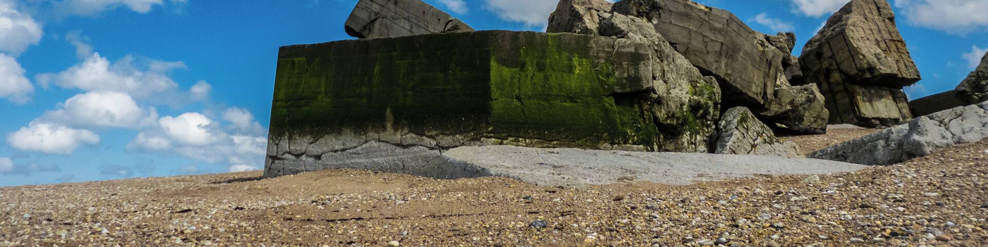 A rocky landscape with large boulders and a clear blue sky.