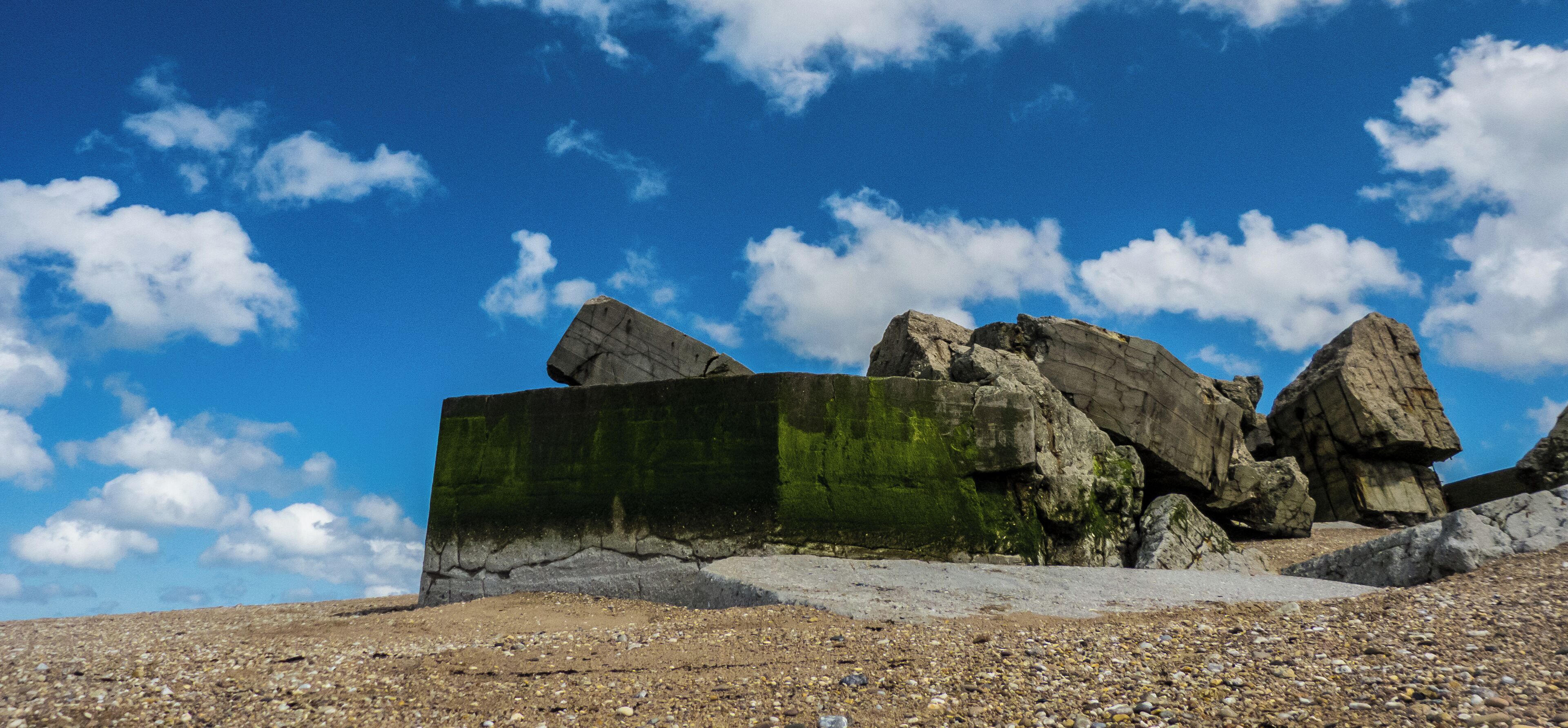 A rocky landscape with large boulders and a clear blue sky.