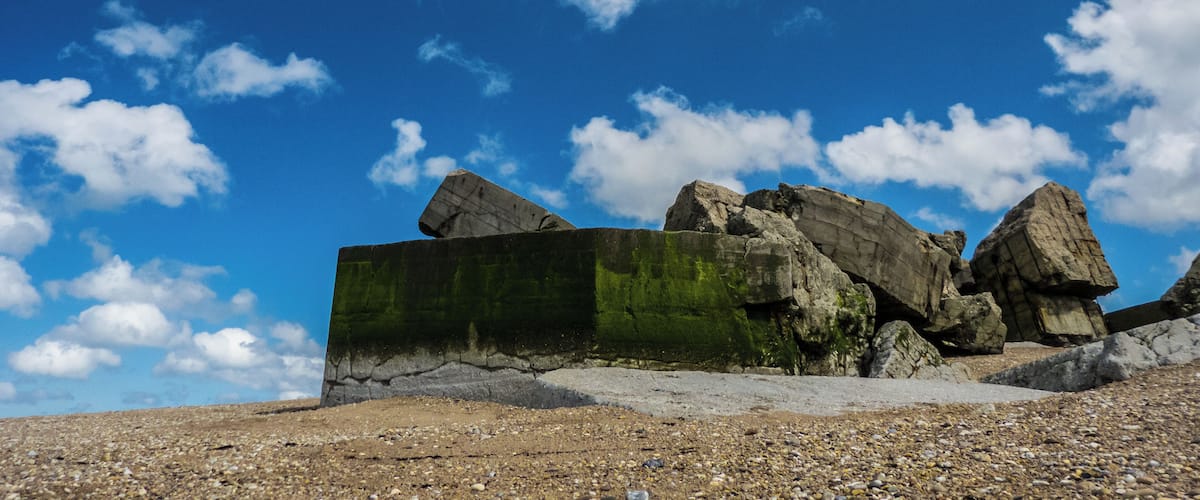 A rocky landscape with large boulders and a clear blue sky.