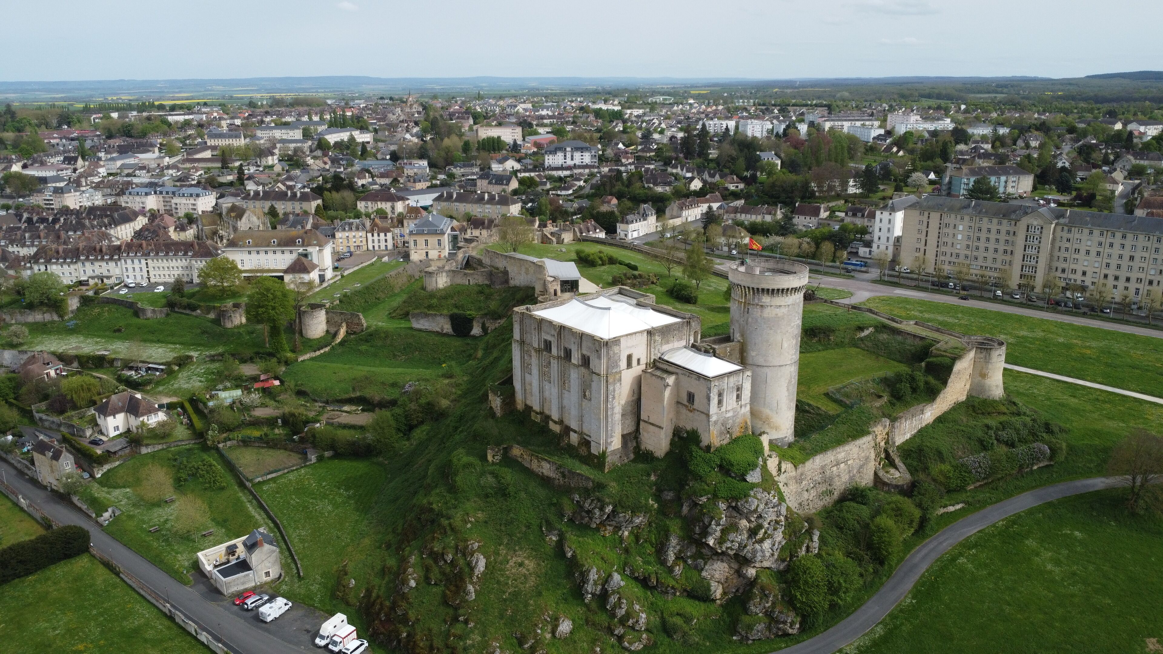 An aerial view of a historic castle surrounded by a town.