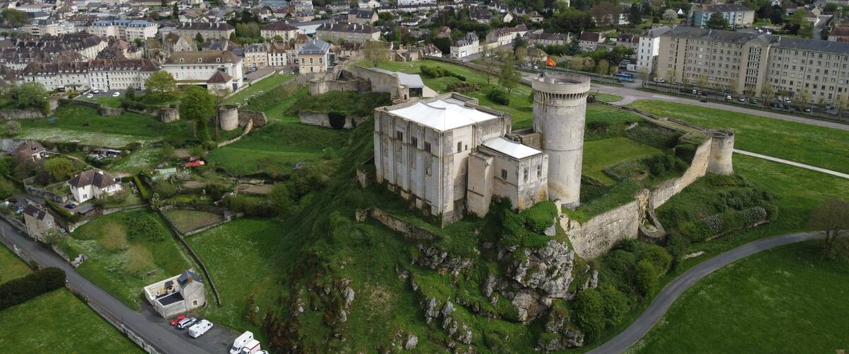 An aerial view of a historic castle surrounded by a town.