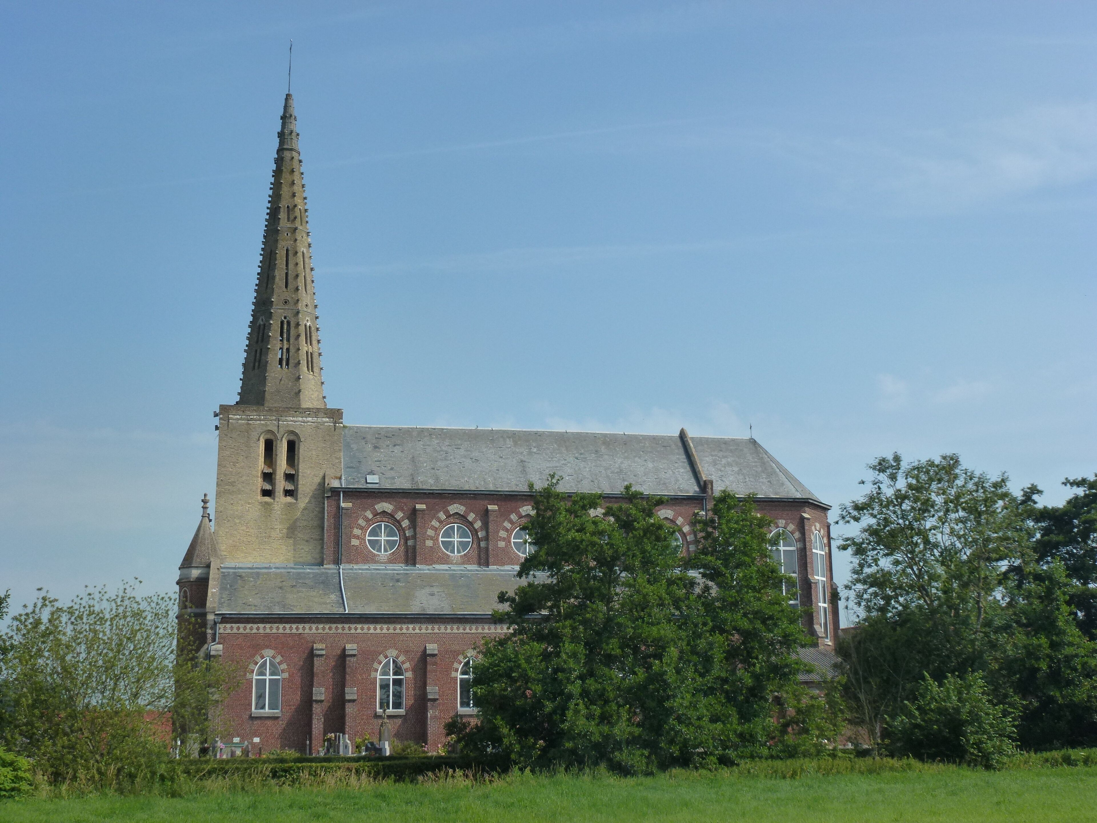 A large church with a tall spire and arched windows.