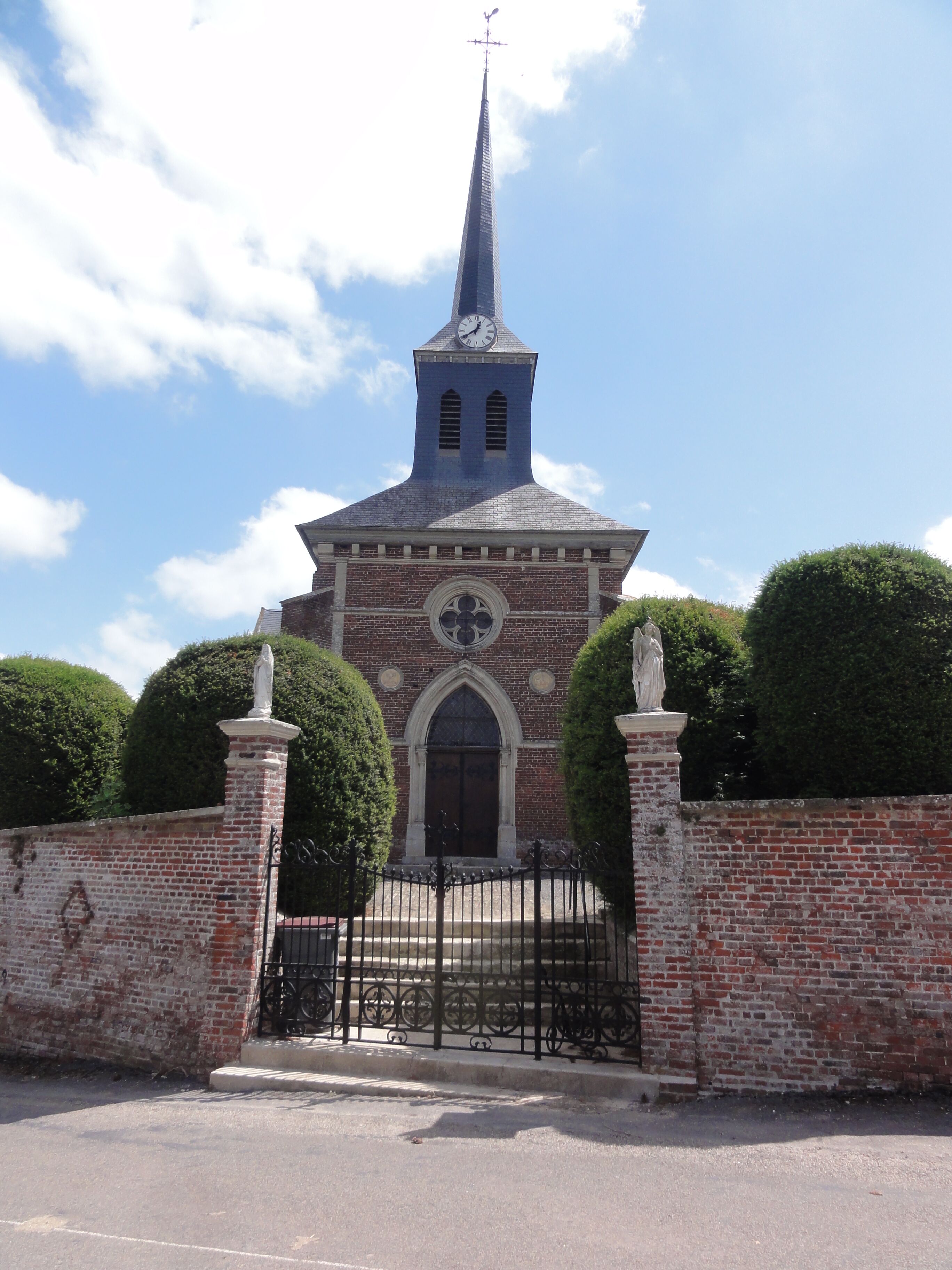 A church with a tall steeple and a clock.