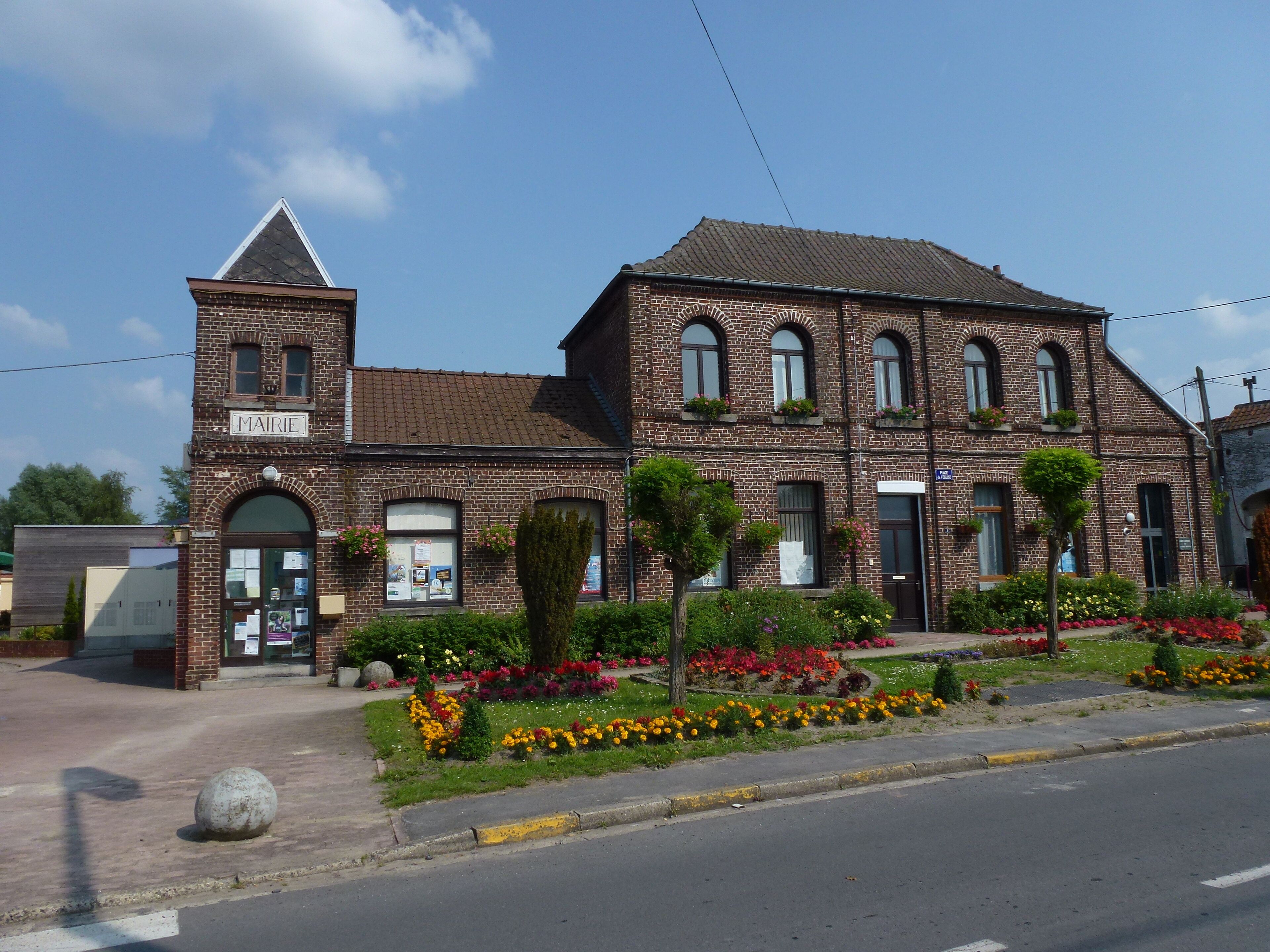 A historic brick building with a sign reading "MAIRIE".