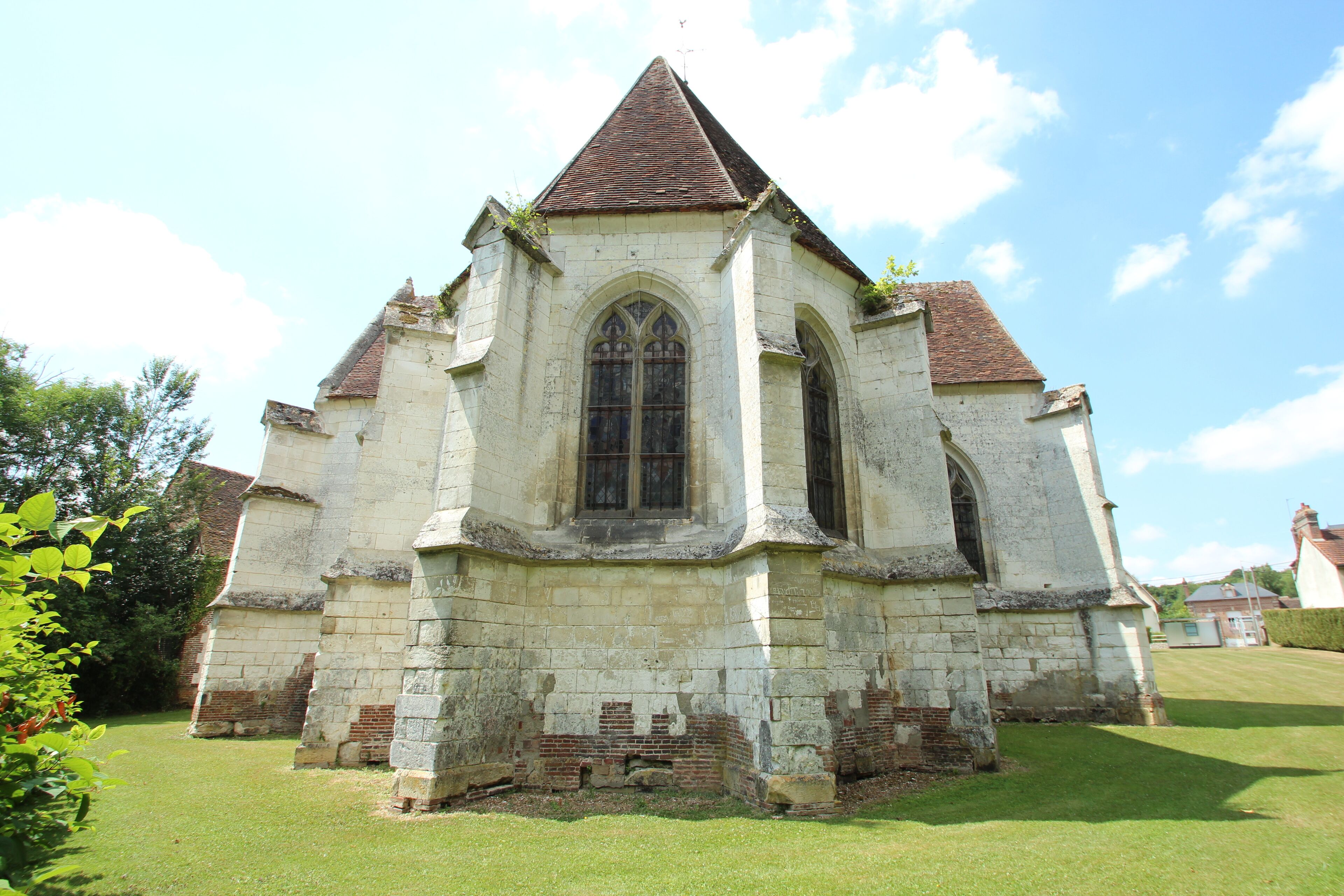 A historic stone church with a pointed roof and arched windows.