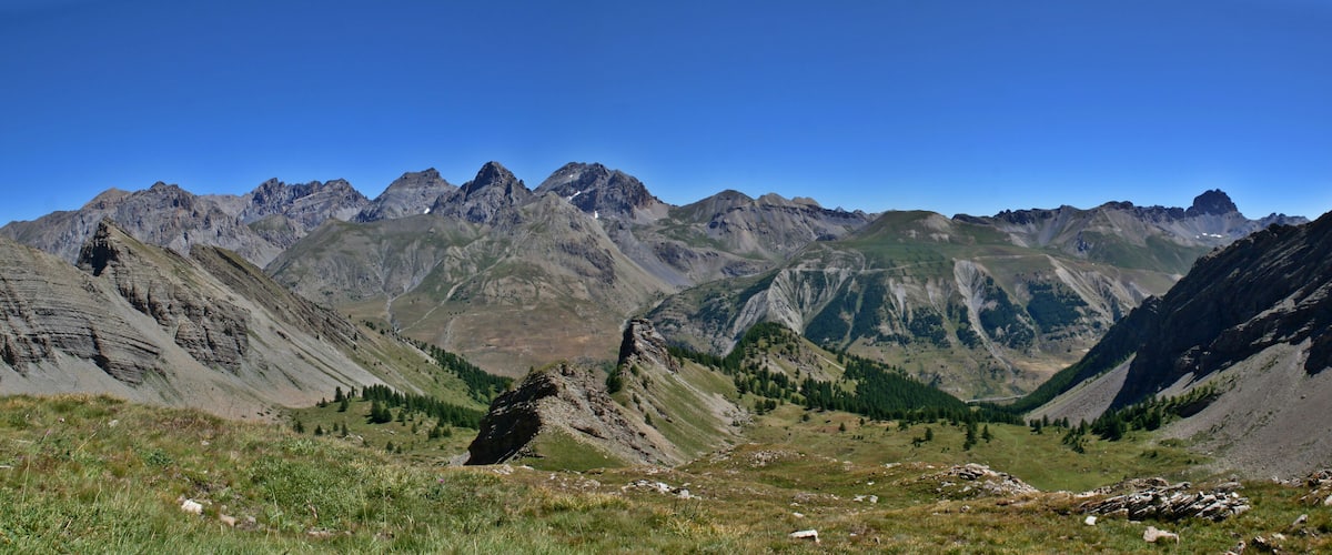 A mountainous landscape with rugged peaks and a valley.