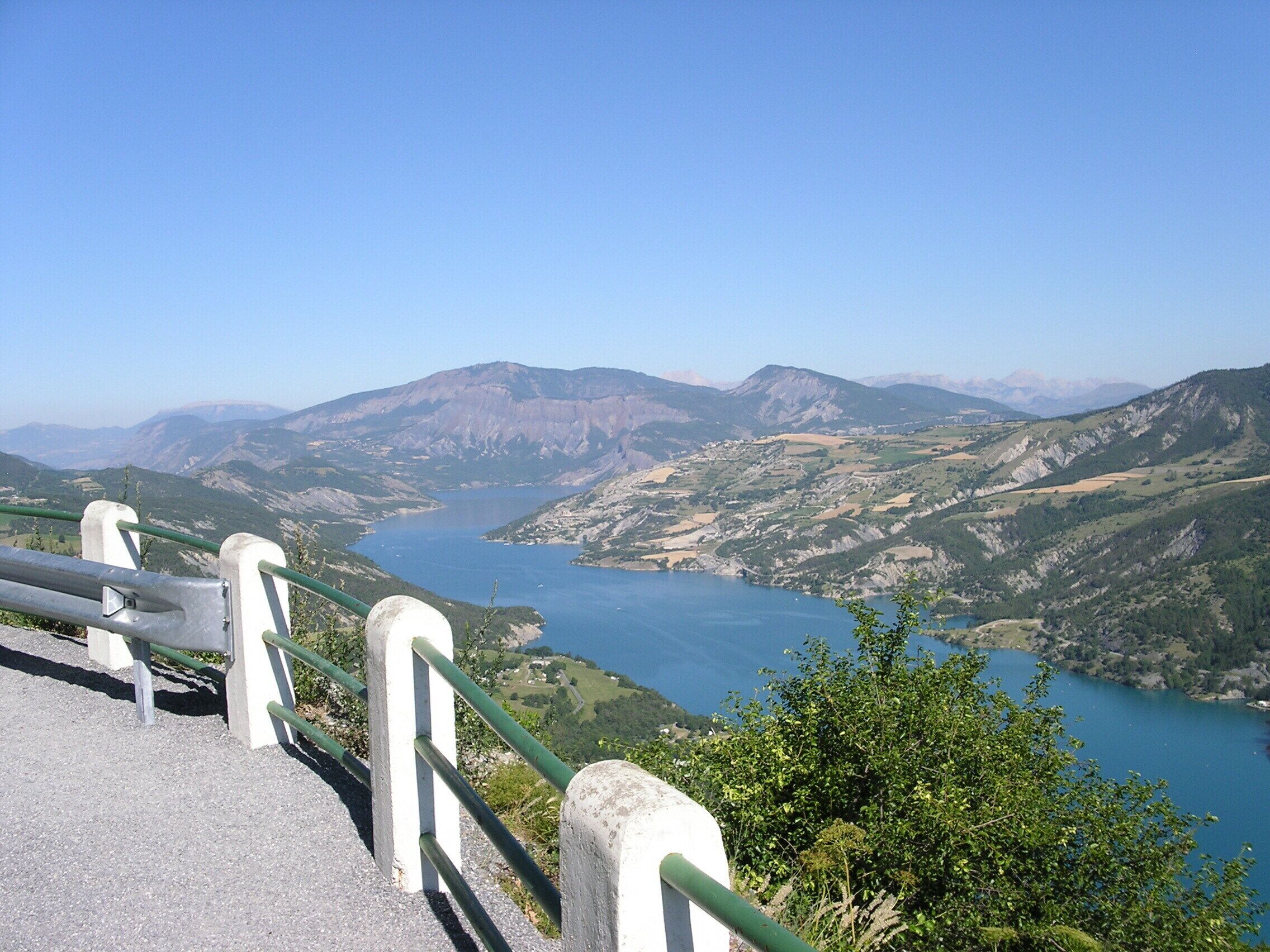 A scenic overlook with a view of a river and mountains.