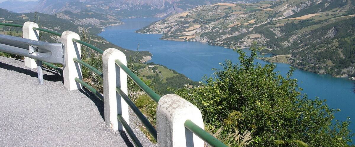A scenic overlook with a view of a river and mountains.