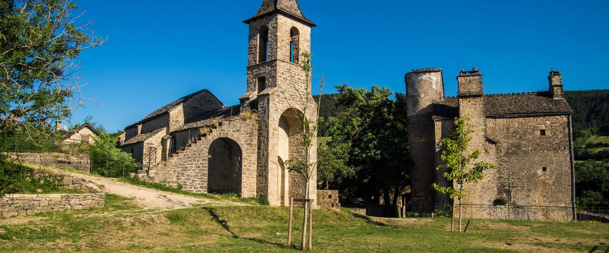 A historic stone church with a bell tower and arched windows.