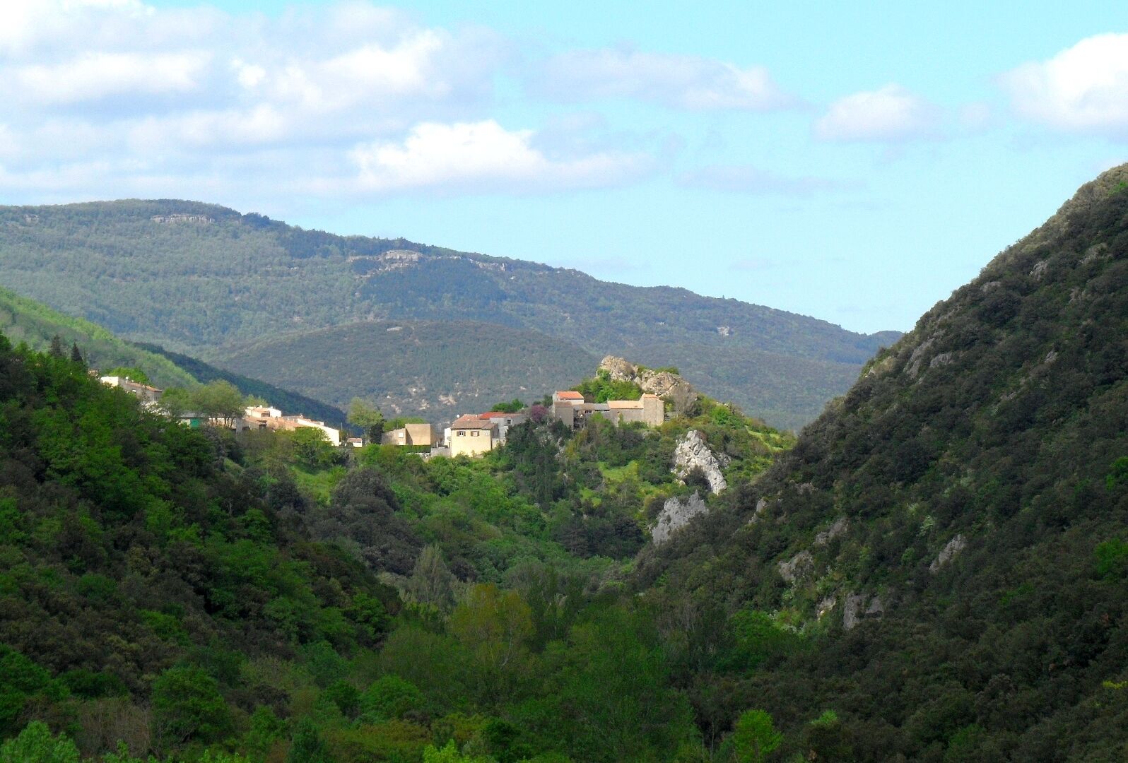 A mountainous landscape with a village nestled among the hills.