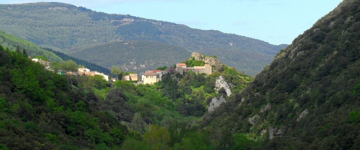 A mountainous landscape with a village nestled among the hills.