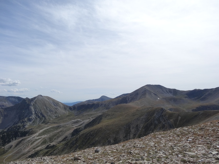 A mountainous landscape with rocky terrain and winding paths.