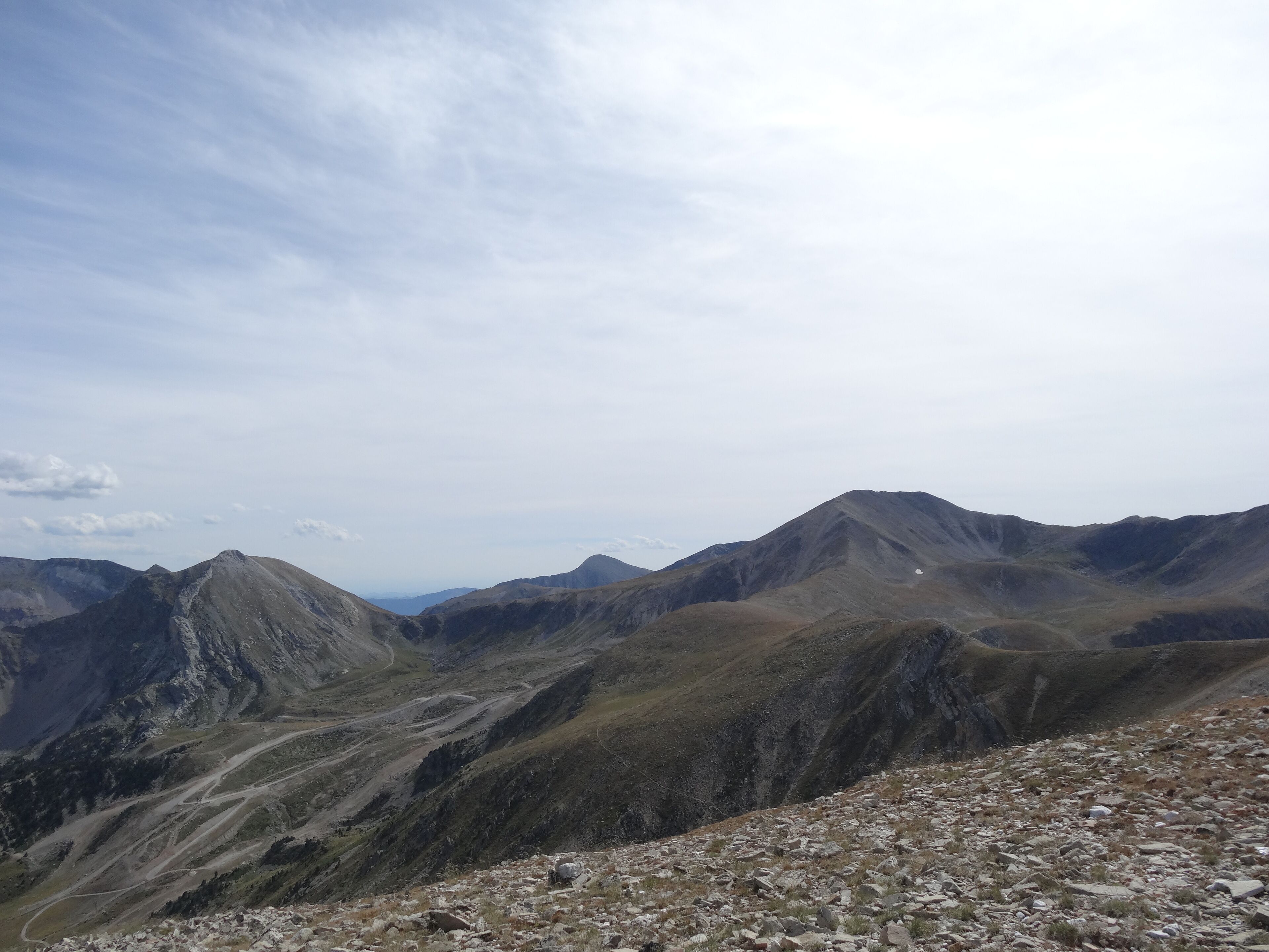 A mountainous landscape with rocky terrain and winding paths.