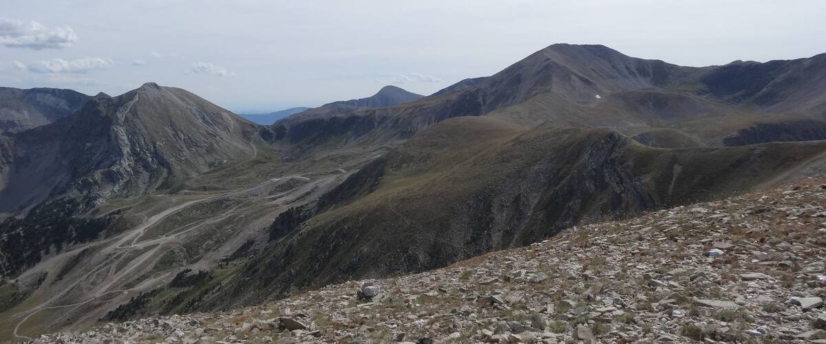 A mountainous landscape with rocky terrain and winding paths.
