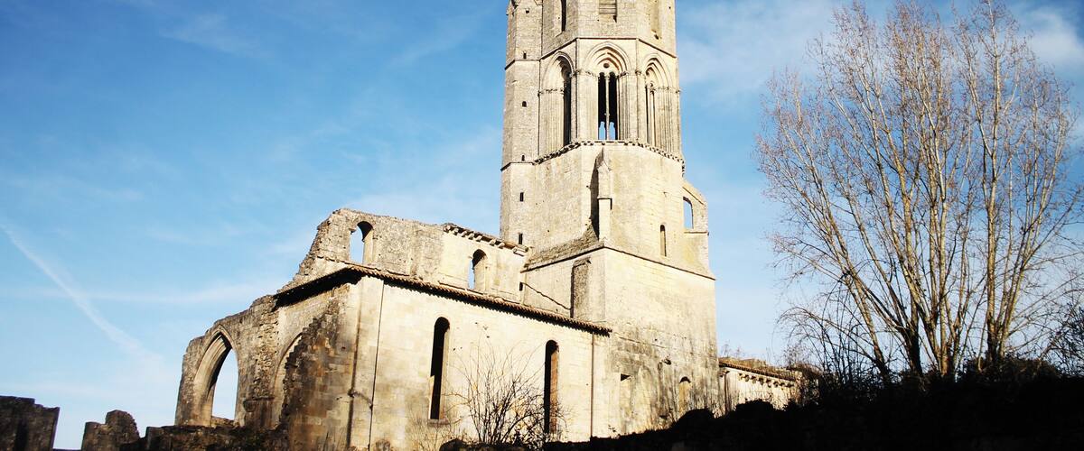 An old stone church with a bell tower and arched windows.