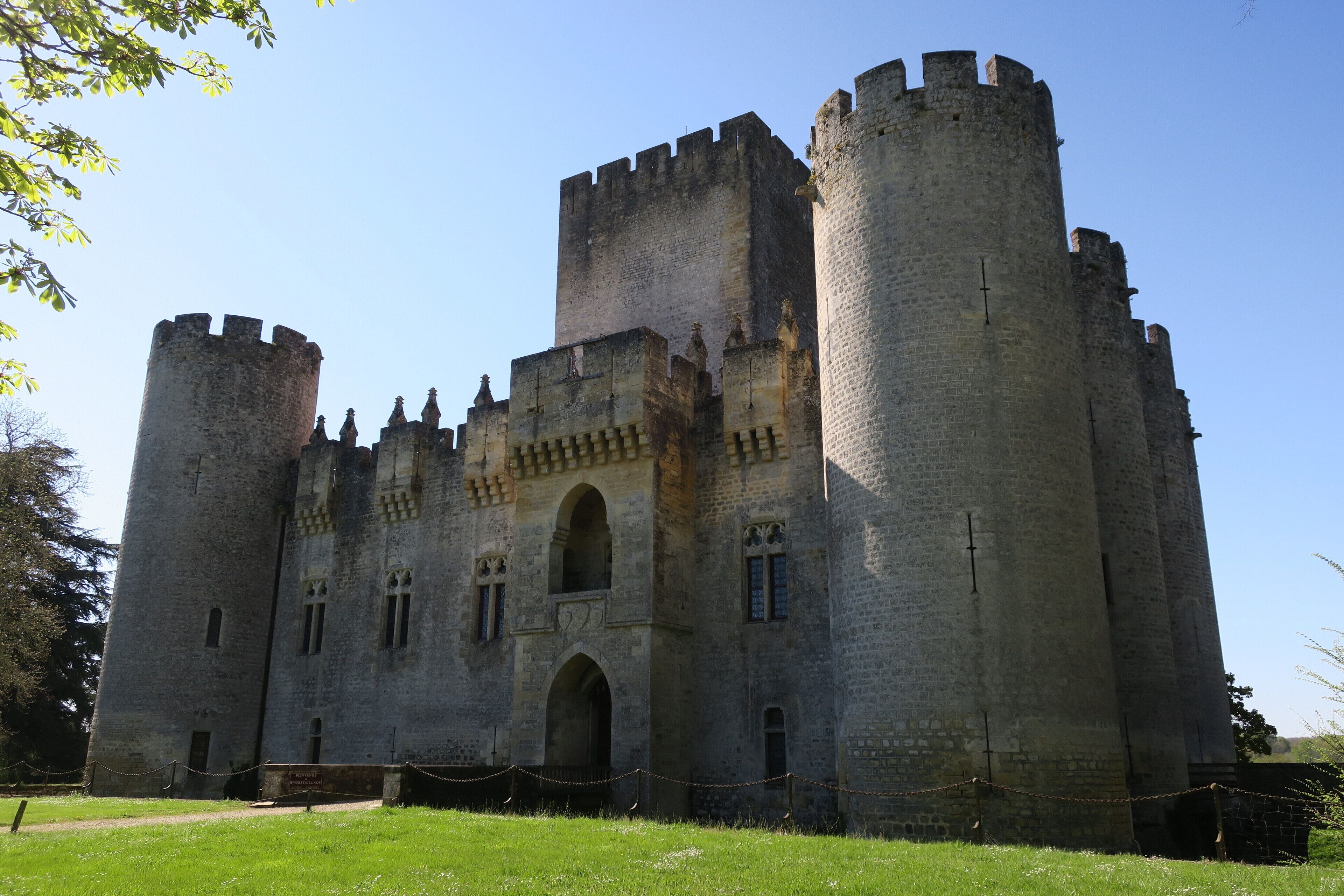 A large medieval castle with two prominent towers and a central arched entrance.
