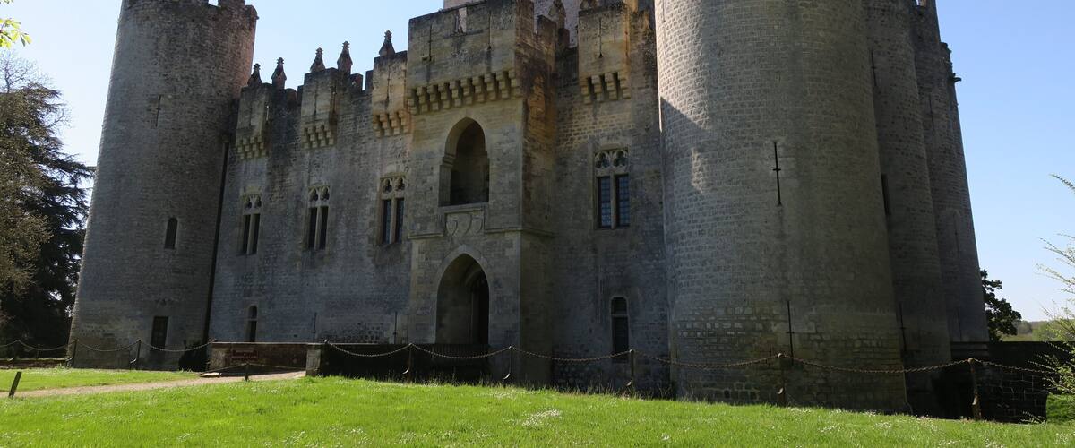 A large medieval castle with two prominent towers and a central arched entrance.