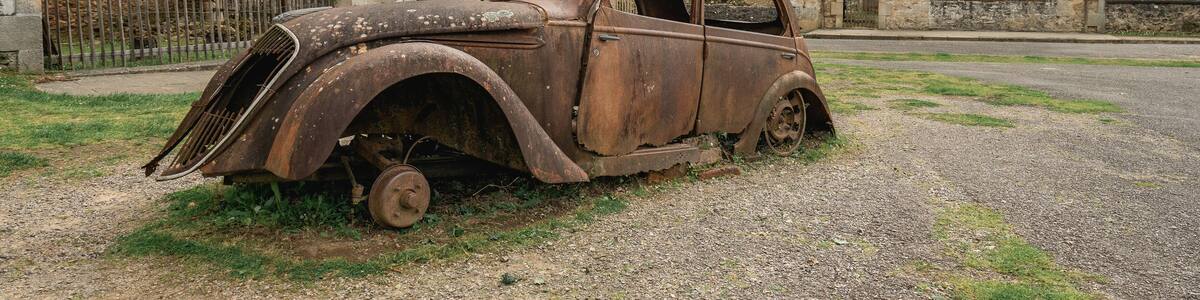 Old rusty cars left behind in Oradour-sur-Gllane, France.