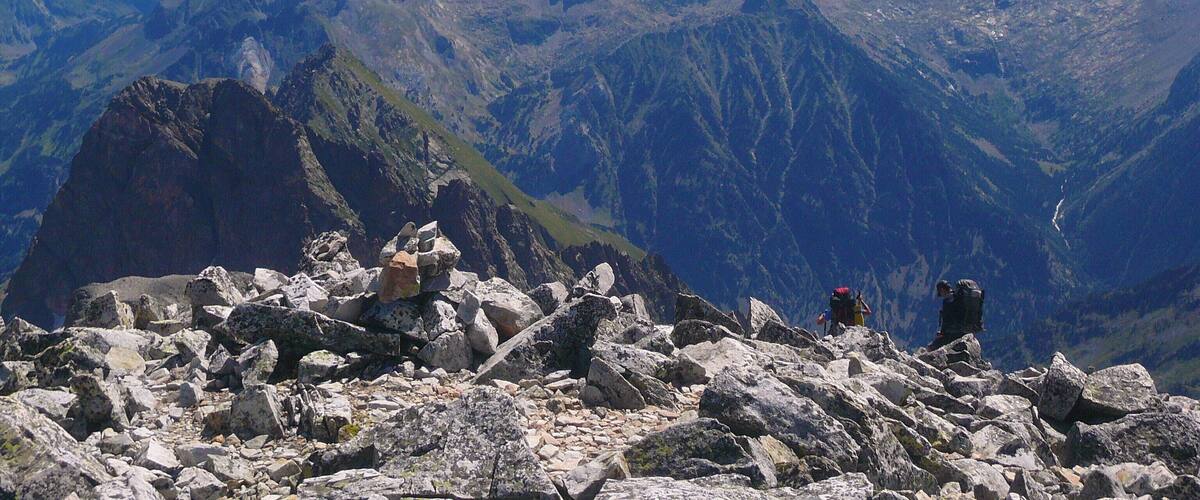 A rugged mountain landscape with rocky terrain and a clear blue sky.