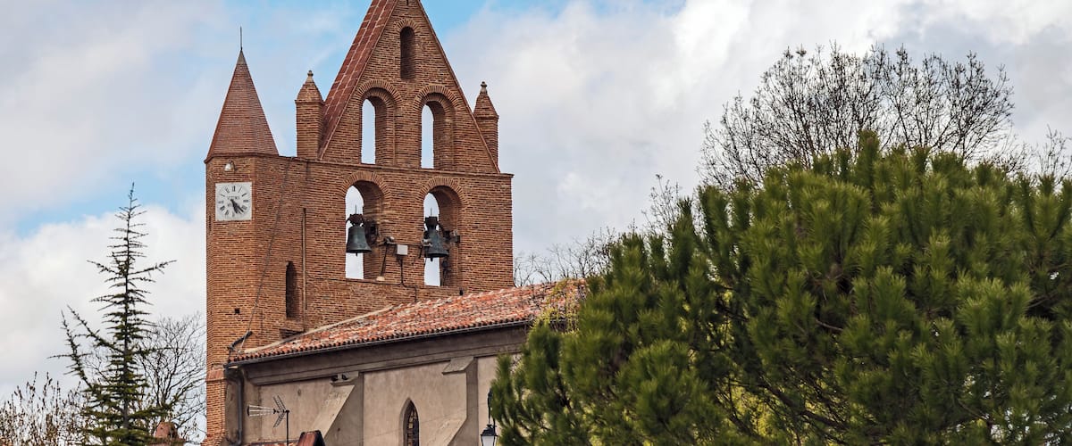 A historic church with a tall bell tower and a clock.
