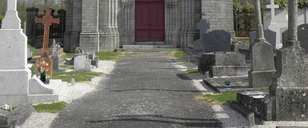 A stone church with a red door and two towers.