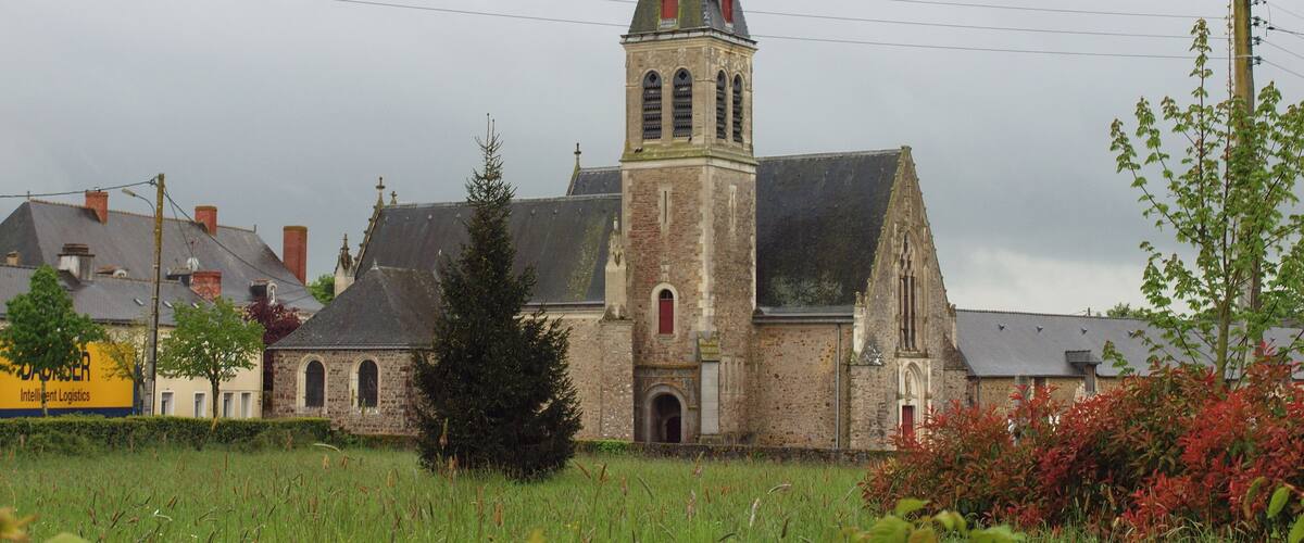 A church with a tall tower and a weather vane.