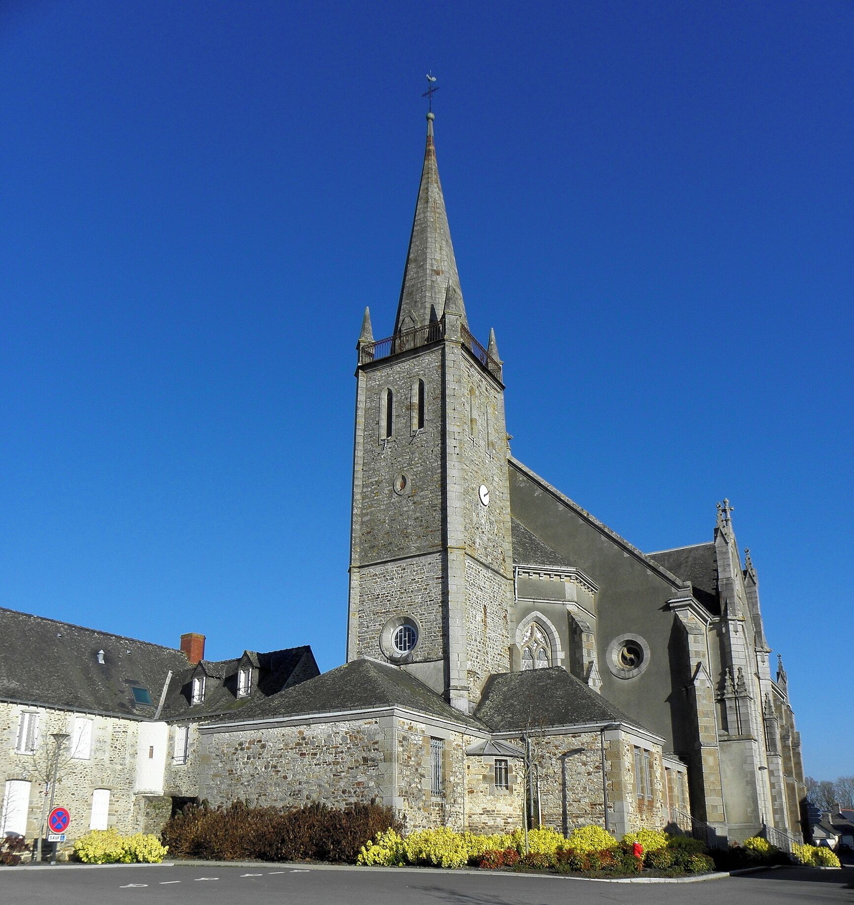 A historic church with a tall spire and stone architecture.
