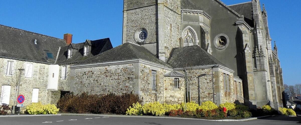 A historic church with a tall spire and stone architecture.