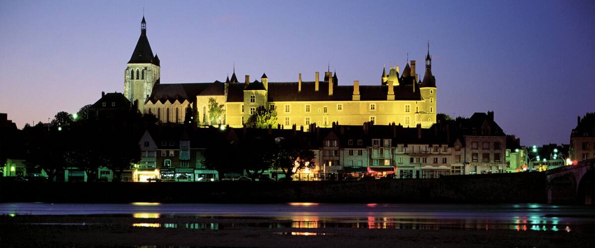 A castle with a tower, a river, and a bridge.