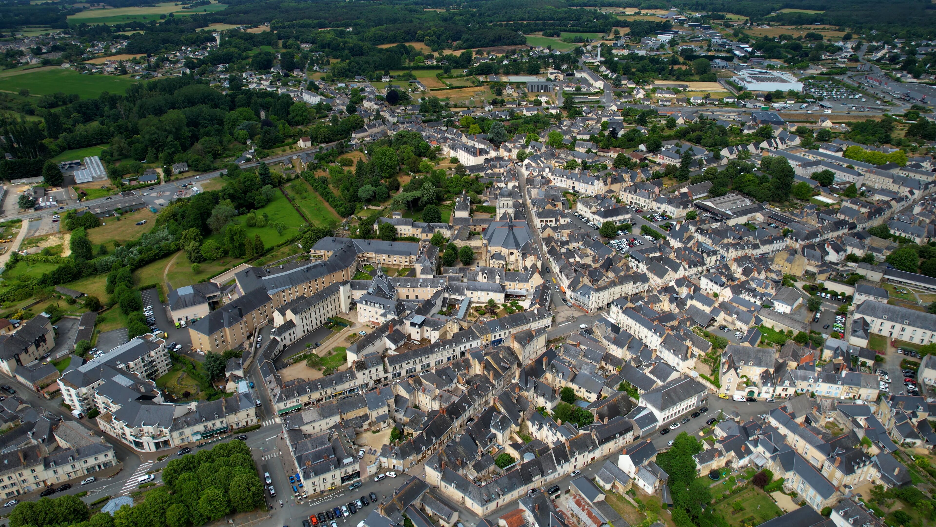  Aerial view around the old town of the city Baugé-en-Anjou in France on a sunny summer morning