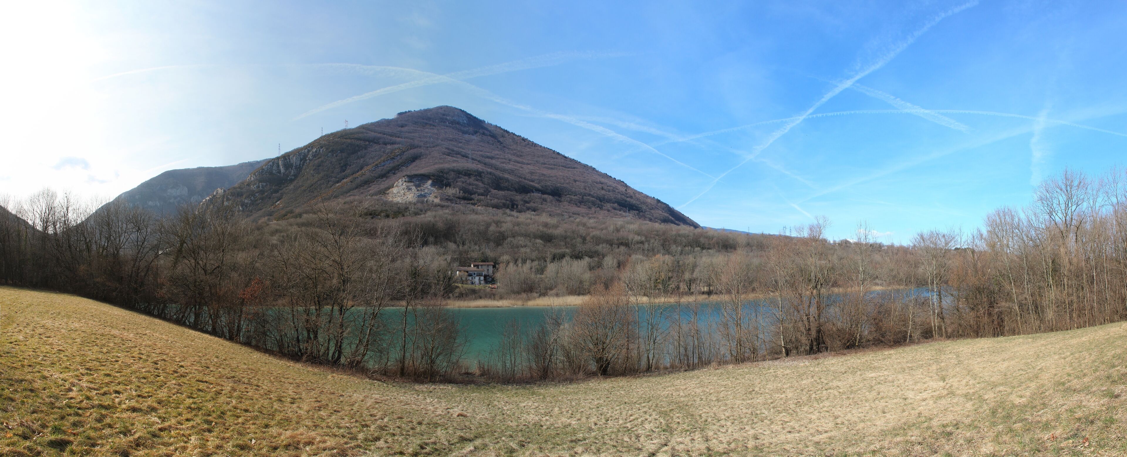 A mountain, a lake, and a house.