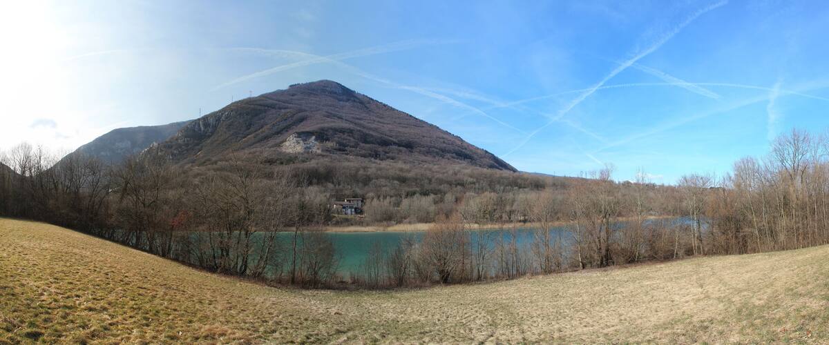 A mountain, a lake, and a house.