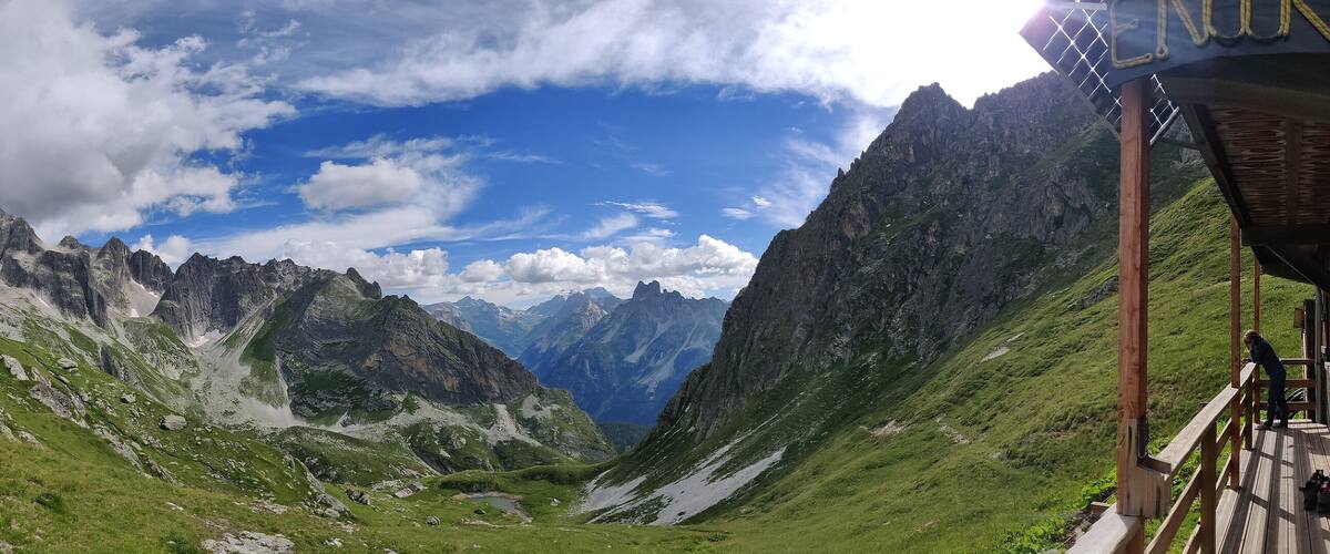 A mountainous landscape with a wooden viewing platform.