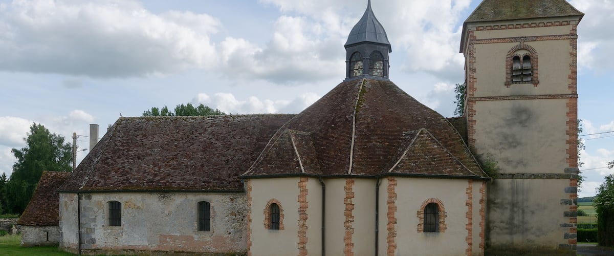 A church with a bell tower and a steeple.