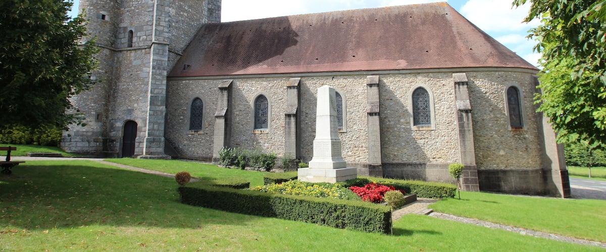 A historic stone church with a tower and arched windows.