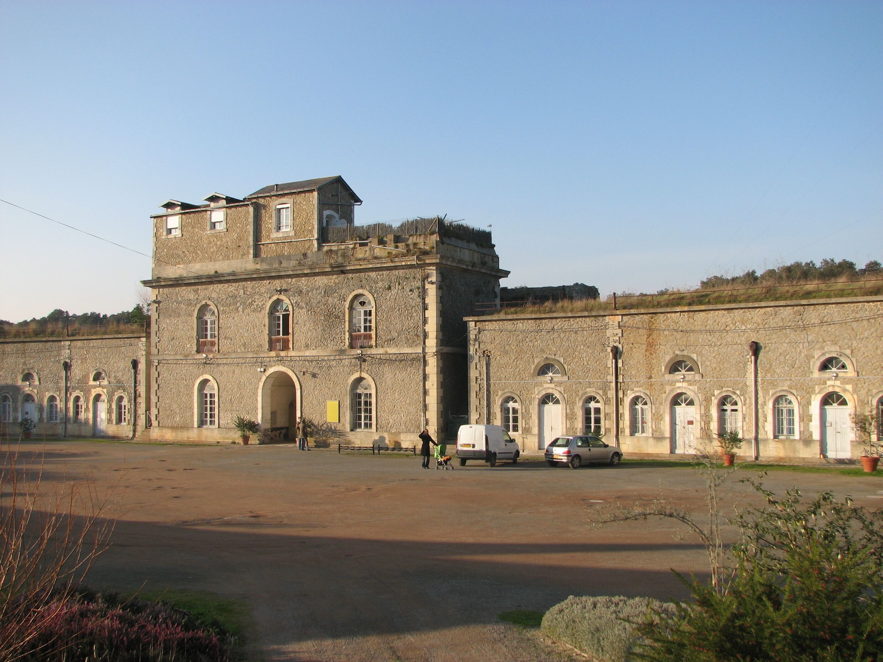 A large stone building with arched windows and a central tower.
