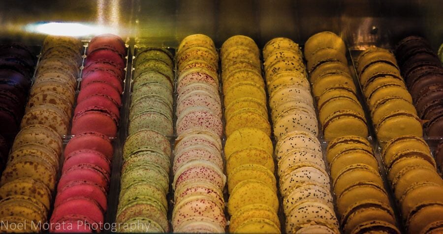 A display of colorful macarons in a glass case.