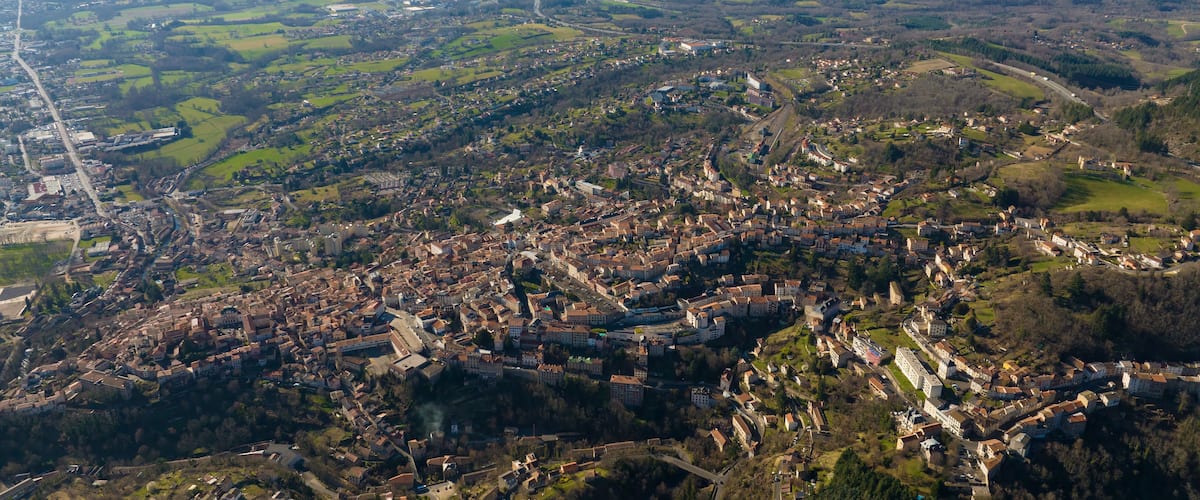 Aerial view of dense historic center of Thiers town in Puy-de-Dome department, Auvergne-Rhone-Alpes region in France. Rooftops of old buildings and narrow streets