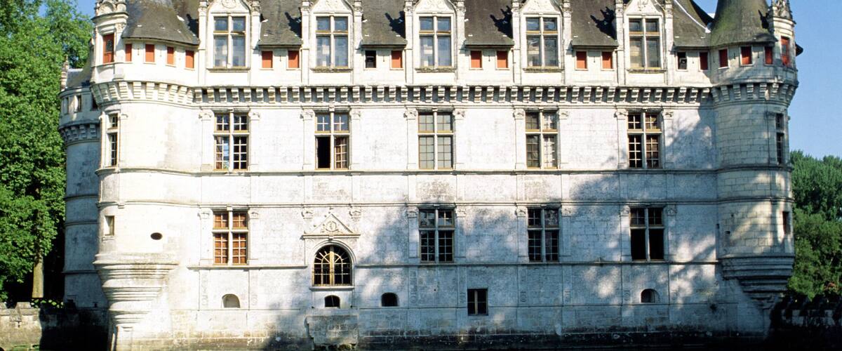A large, historic château with multiple towers and a moat.