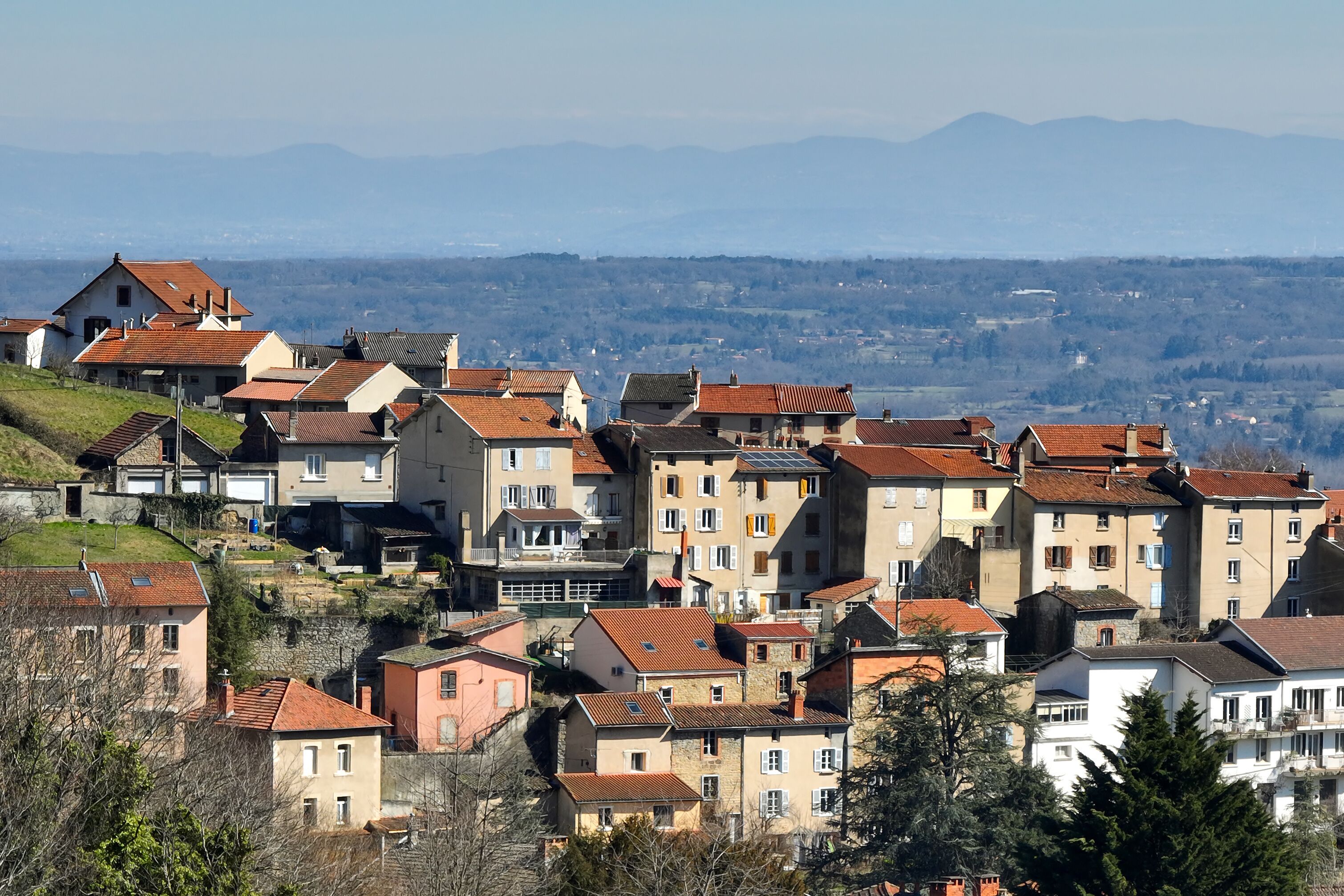 Aerial view of dense historic center of Thiers town in Puy-de-Dome department, Auvergne-Rhone-Alpes region in France. Rooftops of old buildings and narrow streets
