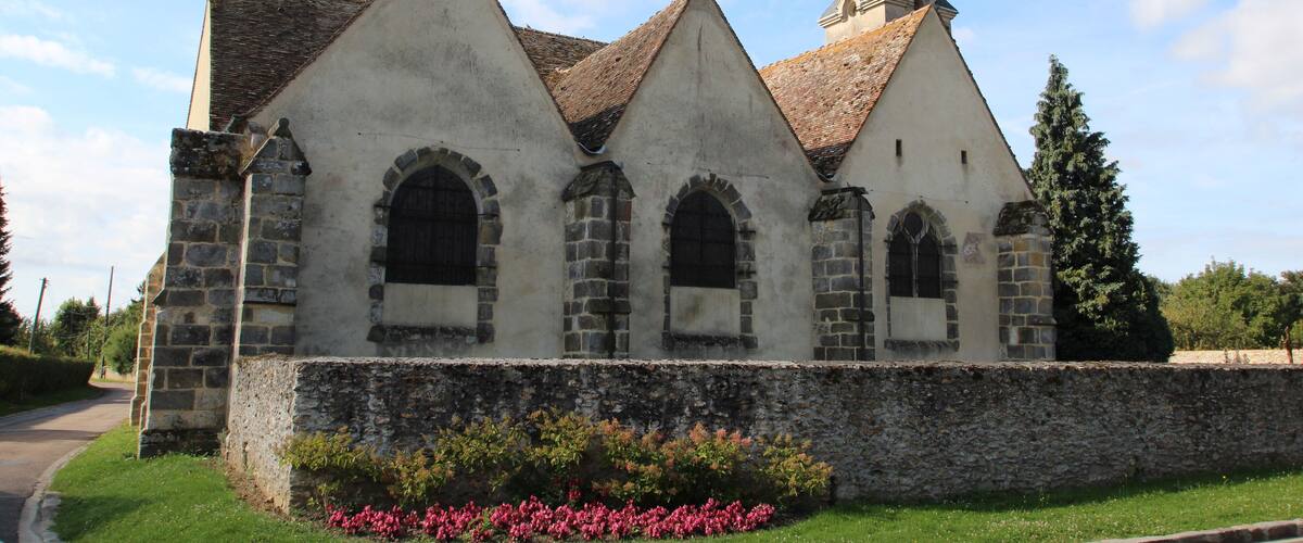 A church with a pointed steeple and arched windows.