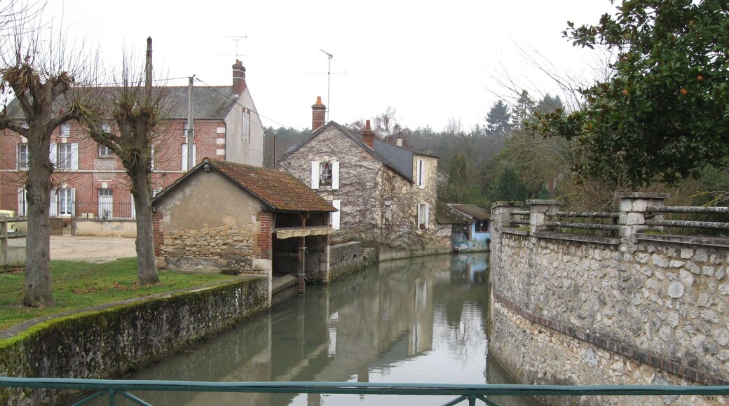 Châtillon-Coligny, Loiret, France. Boulevard de la République, at the corner of the restaurant "Le Coligny". An arm of the Loing river, looking downstream as it's leeaving the moat that runs against what used to be the town defence wall (the moat is immediately upstream from this bridge, behind us).