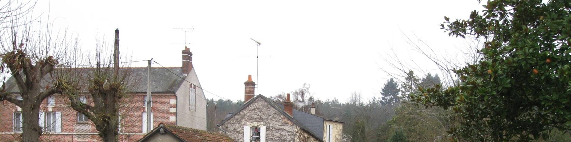 Chùtillon-Coligny, Loiret, France. Boulevard de la République, at the corner of the restaurant "Le Coligny". An arm of the Loing river, looking downstream as it's leeaving the moat that runs against what used to be the town defence wall (the moat is immediately upstream from this bridge, behind us).