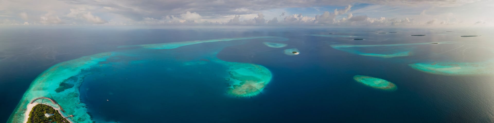 Panoramic aerial view of tropical island in the morning, Baa Atoll, Maldives.