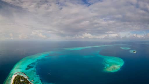 Panoramic aerial view of tropical island in the morning, Baa Atoll, Maldives.