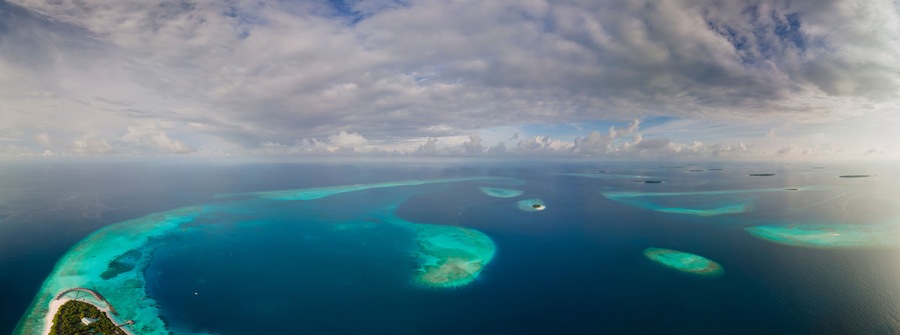 Panoramic aerial view of tropical island in the morning, Baa Atoll, Maldives.