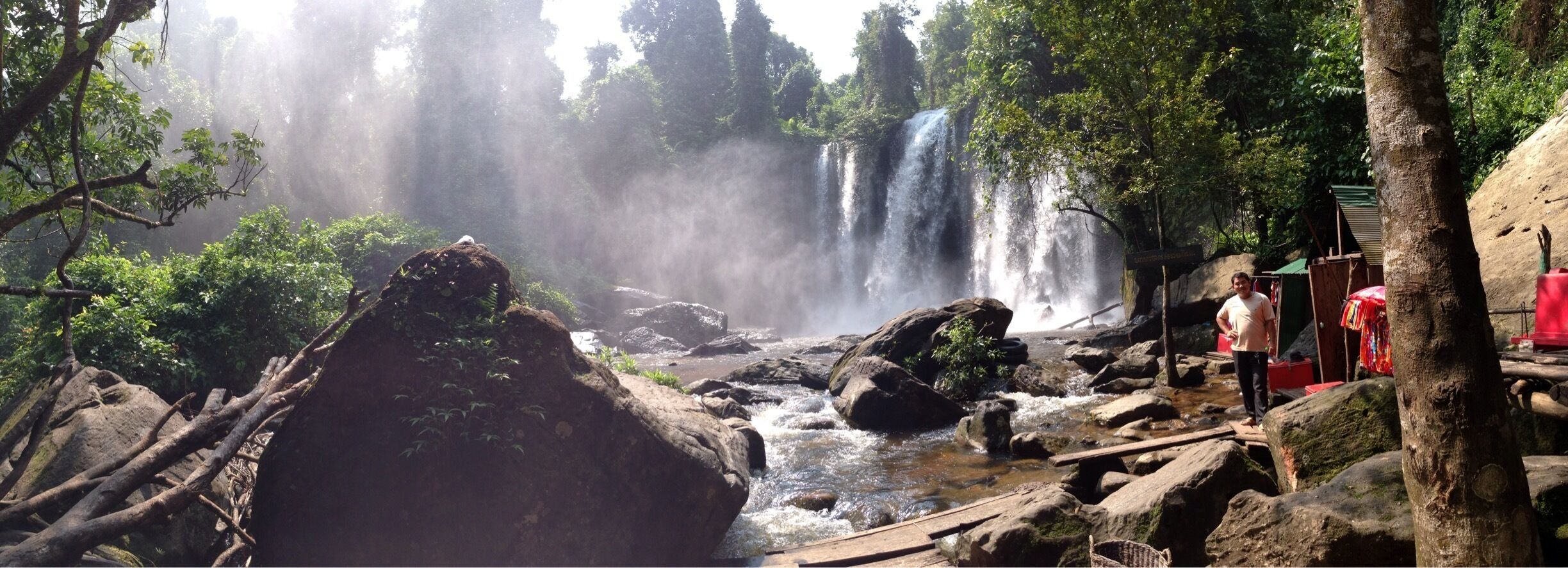 A waterfall surrounded by rocks and trees.