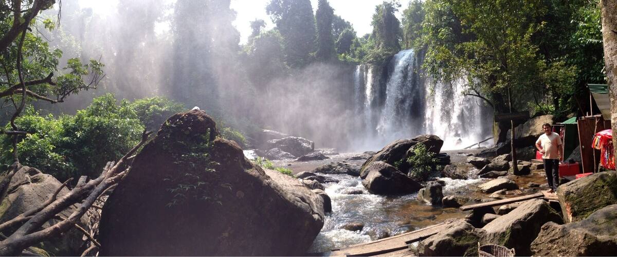 A waterfall surrounded by rocks and trees.