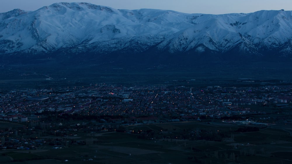 Evening view from the height of the city of Erzincan. Snowy Munzur mountains on the horizon