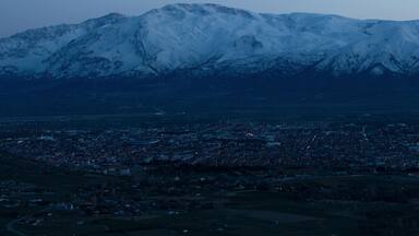 Evening view from the height of the city of Erzincan. Snowy Munzur mountains on the horizon